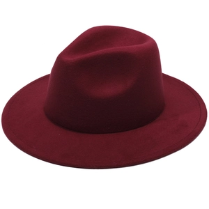 Detail view of red wide brim wool felt hat with wavy edge and vintage fedora style