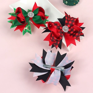 Detailed view of Christmas bow clips with rhinestones on a decorative ceramic plate