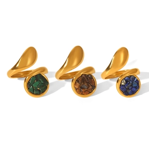 Three gold stainless steel rings set with green, brown and blue stones on white background