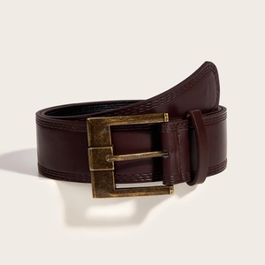 Detail of dark brown leather belt with vintage brass rectangular buckle and double stitching