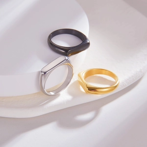 Detailed set of polished rectangular signet rings in gold, silver, and black finishes