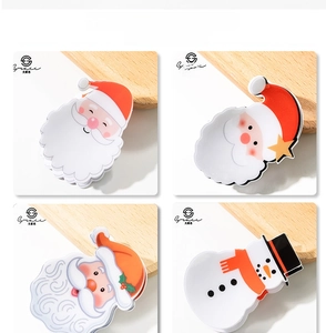 Macro detail of Christmas themed ceramic plates featuring Santa and snowman holiday designs