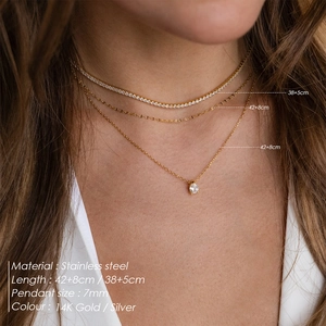 Detail view of layered stainless steel gold necklaces with 7mm pear and square pendants