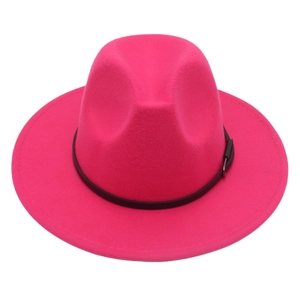 Detail of rose red wide brim fedora hat featuring black leather band and silver buckle