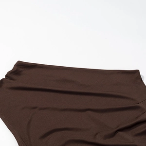 Close-up of brown satin dress fabric texture showing high-quality stitching details