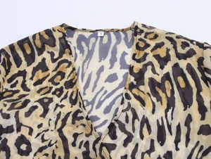 Detail of the deep V-neck and sheer leopard print mesh fabric texture in size S