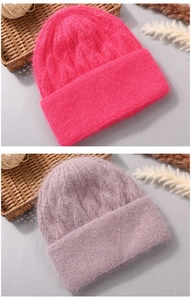 Close-up of fluffy angora rabbit fur knit beanies with twist texture and wide fold-over cuffs