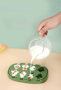 Detail of pouring milk and strawberry into cartoon shaped silicone ice cube mold