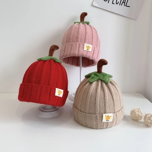 Cute baby pumpkin knit hats in red, pink, and khaki with green leaf detail for winter