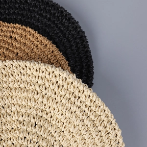 Close-up of premium woven straw texture in black, brown and cream white summer hat colors