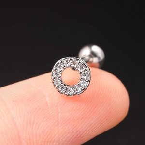 Close-up of a silver stainless steel screw-back earring with sparkling zircon stones