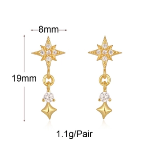 Detail of gold star earrings showing 8mm width and 19mm length product dimensions
