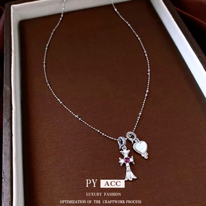 Cross and mother-of-pearl heart pendant necklace with zircon on a wooden tray