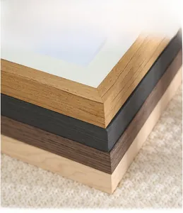 Close-up of four solid wood picture frame corners in oak, black, walnut and natural wood