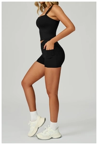 Detail shot of black high-waisted yoga shorts with a functional side pocket for phone