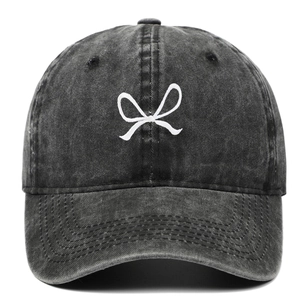 Detail of white bow embroidery on washed cotton dark grey vintage baseball cap