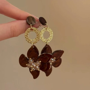 Detail shot of vintage resin flower earrings with gold metal rings and crystal beads