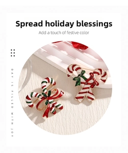 Macro detail of Christmas candy cane brooches with red white enamel and gold plating