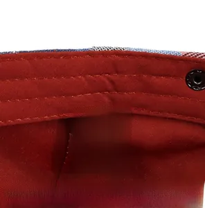 Macro shot of cotton blend inner lining and wash label on a plaid flat cap