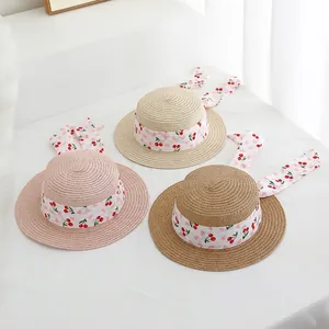 Three kids straw hats with cherry print ribbons in pink, beige and brown colors