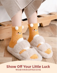 Detail of coral fleece bear socks paired with plush open-toe slippers on wooden floor