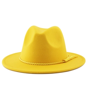 Close-up of bright yellow felt fedora hat featuring a woven band with tassel details