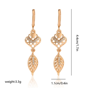 Detail view of champagne gold leaf earrings with zircon hearts and size measurements