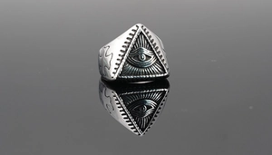 Macro detail of gothic titanium steel ring with Eye of Providence and cross engraving