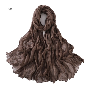 Detail view of the fine vertical pleats on a breathable dark brown linen cotton scarf