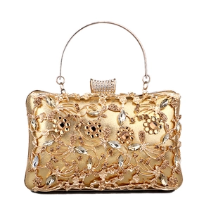 Luxurious gold evening clutch bag with floral diamond patterns and round metal handle