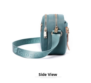 Side view of multi-compartment nylon crossbody bag with wide adjustable shoulder strap