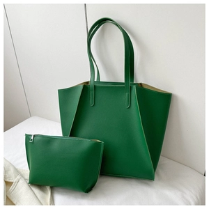 Detail view of green textured leather tote bag set including a small matching zipper pouch