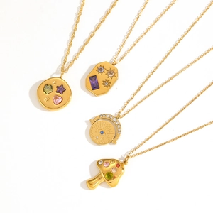 Close-up of four gold pendant designs featuring celestial stars and colorful zircon stones