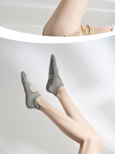 Close-up of grey cotton yoga socks with non-slip grip dots and open-back cut-out design