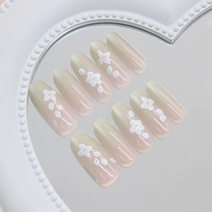 Handmade gradient mint cat-eye press-on nails with white 3D floral art on mirror tray