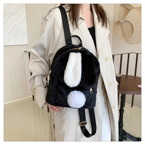 Detail of cute lamb wool bunny backpack with long white ears and plush texture