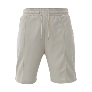 Detail of light grey waffle knit shorts with elastic drawstring waist and vertical seam