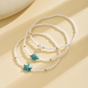 Detail of bohemian starfish charms and turquoise beads on elastic anklet set