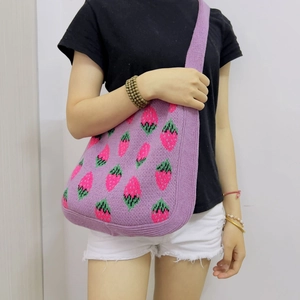 Purple knitted strawberry tote bag featuring pink patterns and a wide shoulder strap