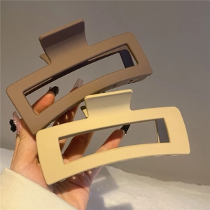 Matte brown and beige resin shark hair claws in a minimalist rectangular hollow design
