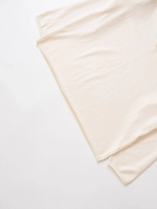 Detail of ribbed hem and cuffs on cream white wool blend lace knit sweater