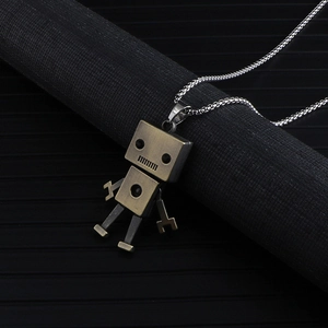 Close-up of a vintage bronze robot pendant with movable limbs on a silver chain