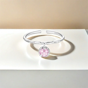 Macro view of S925 sterling silver adjustable ring with pink cubic zirconia charm