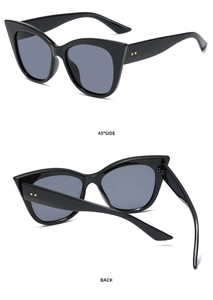 Detail view of black cat-eye sunglasses featuring golden metal accents and 45 degree side profile