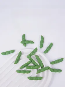 Detailed view of artificial green edamame pods with realistic texture on white tray