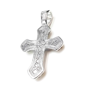 Macro shot of silver cross pendant with intricate embossed floral carvings and textures