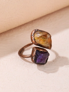 Macro detail of bronze adjustable ring with irregular raw amethyst and citrine stones