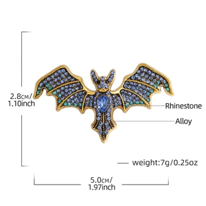 Vintage bat brooch with blue crystals and gold alloy frame, size 2.8cm x 5.0cm