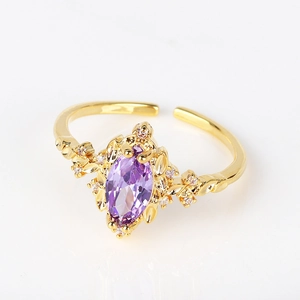 Detail of vintage gold ring with purple marquise zircon and sparkling white accents