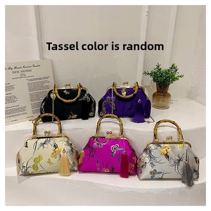 Detail of vintage silk embroidery bags with bamboo handles and elegant tassels